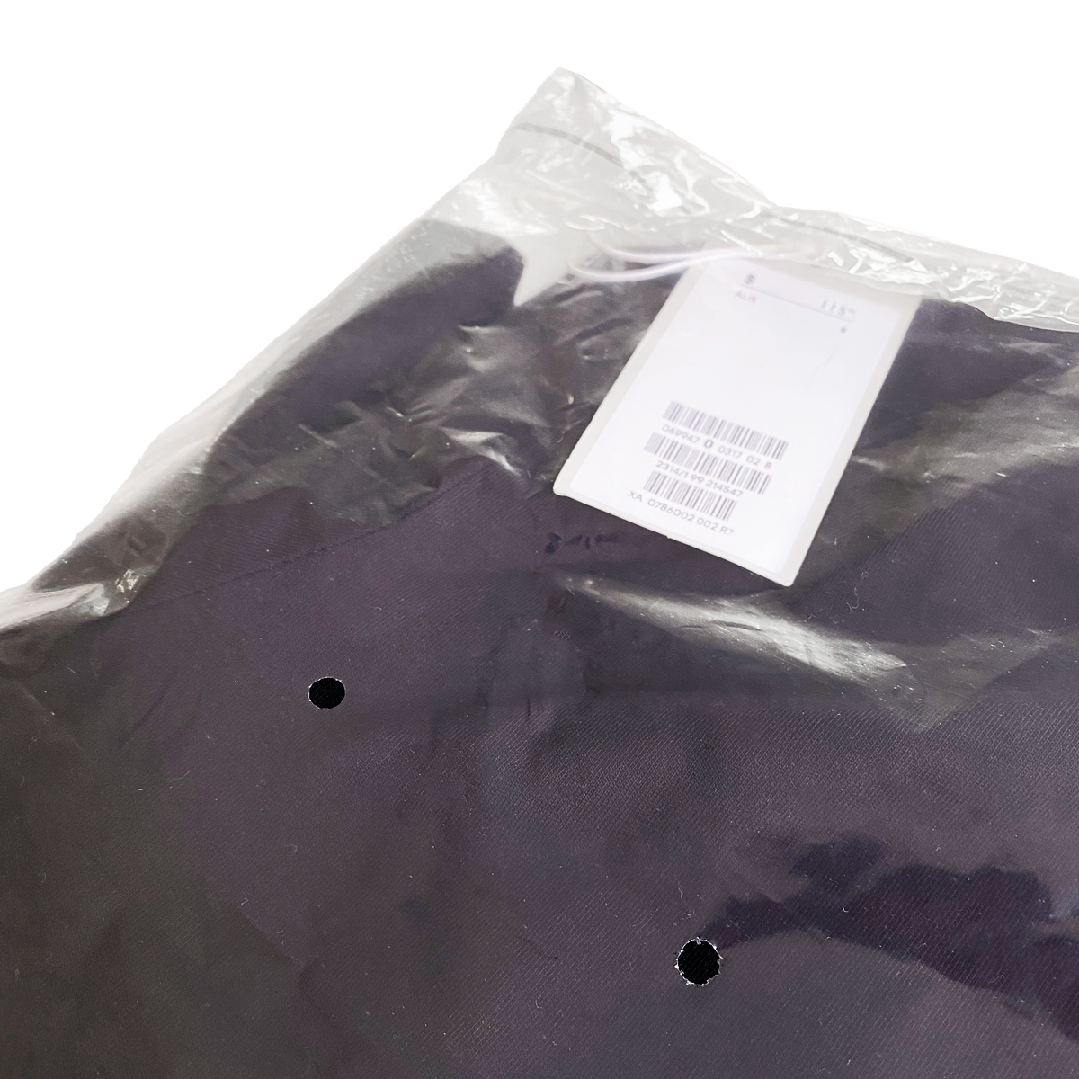 Close up of Better Packaging POLLAST!C poly garment bag with ventilation holes and shirt with barcode tag